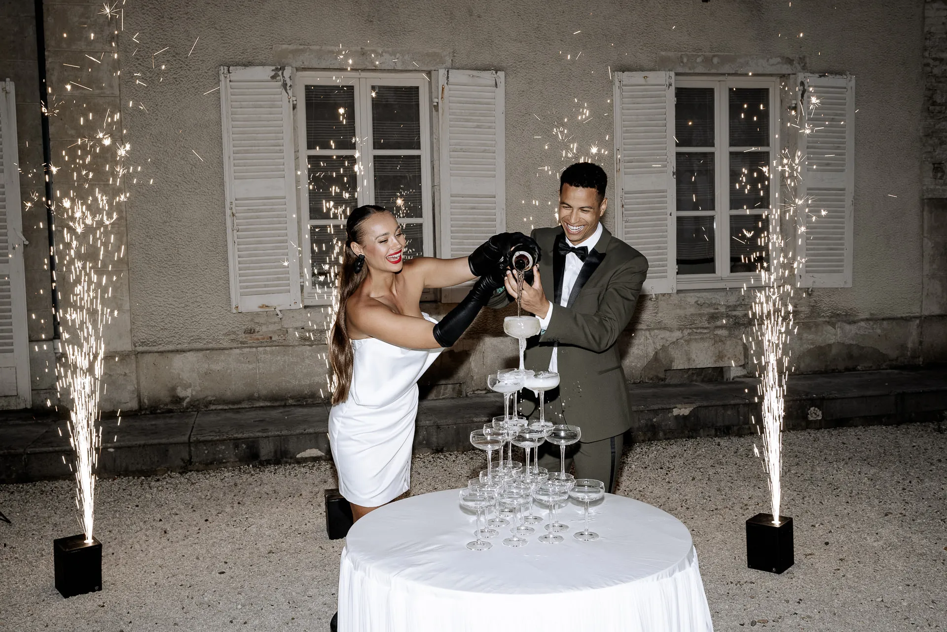 Spectacular champagne tower with fireworks at luxury wedding at Chateau de Varennes in the evening